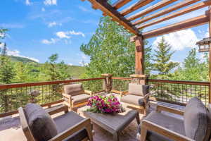 Wooden deck with outdoor lounge area and a pergola