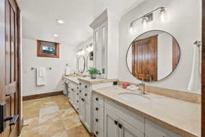 Bathroom featuring oversized vanity and tile floors