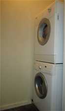 Stacked washer and clothes dryer off of kitchen