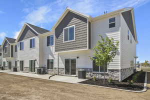 Rear view of property with a patio area, Listed home will have fence partition between immediately adjacent patio  *Photo is of a previously build home. Listed Home is not an end unit.*