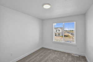 Bedroom 2 featuring a large window and carpet