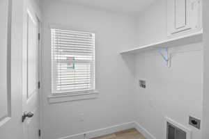 Washroom with washer hookup, light hardwood / wood-style flooring, and electric dryer hookup