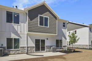 Back of property featuring a patio area. *Photo is of a previously build home. Listed Home is not an end unit.*