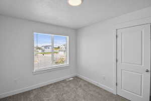 Bedroom 2 featuring a large window and carpet