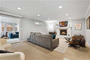 Carpeted living room with crown molding