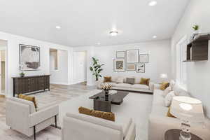 Living room featuring wood finished floors and recessed lighting