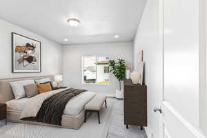 Carpeted bedroom with recessed lighting and a textured ceiling