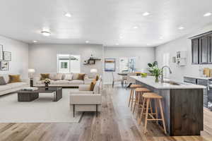 Living area featuring light wood finished floors, recessed lighting, and a textured ceiling