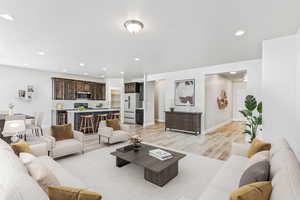 Living room with light wood-style floors and recessed lighting
