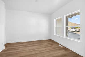 Empty room with wood finished floors and a mountain view