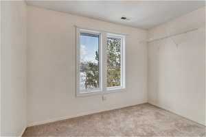 Spare room with plenty of natural light and light carpet