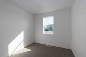 Empty room with dark colored carpet