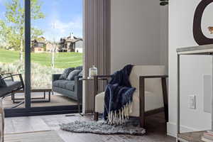 Sitting room featuring wood finished floors and healthy amount of natural light
