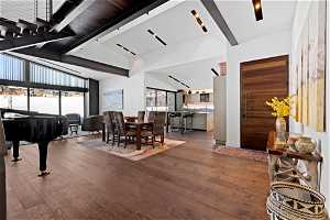 Interior space with dark hardwood / wood-style flooring and high vaulted ceiling