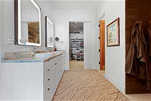Bathroom with large vanity and tile floors