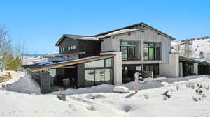 Snow covered property with a balcony