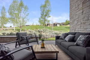 View of patio featuring an outdoor living space and a wooden deck