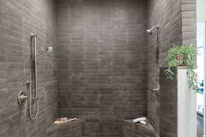 Full bathroom featuring a tile shower