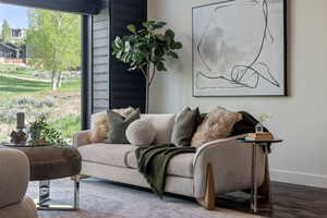 Living area with baseboards and wood finished floors