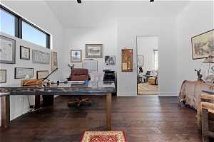 Office featuring ceiling fan, dark wood-type flooring, and high vaulted ceiling
