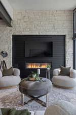 Living area with a glass covered fireplace