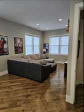 Family  room featuring a wealth of natural light and dark hardwood / wood-style floors