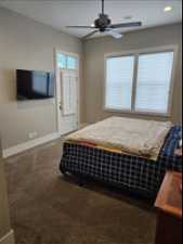 Primary Bedroom featuring dark colored carpet and ceiling fan