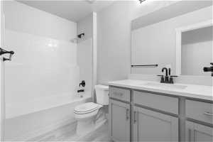 Full bathroom featuring washtub / shower combination, vanity, and toilet