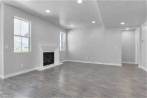 Unfurnished living room featuring hardwood / wood-style floors