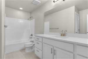 Full bathroom with tub / shower combination, toilet, tile flooring, and oversized vanity