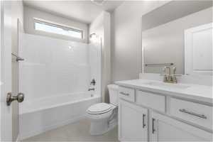 Full bathroom with tile floors, shower / bathing tub combination, toilet, and vanity