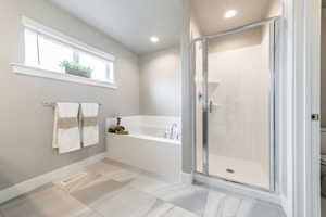 Bathroom with plus walk in shower, tile flooring, and toilet