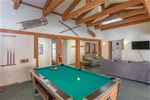 Recreation room featuring billiards, beam ceiling, dark carpet, and high vaulted ceiling