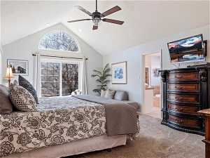 Bedroom with ensuite bathroom, high vaulted ceiling, carpet flooring, and ceiling fan