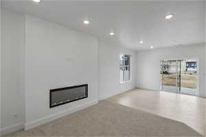 Unfurnished living room with light colored carpet