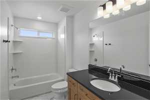 Full bathroom with tile floors, vanity, toilet, and bathing tub / shower combination