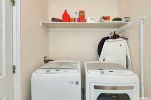 Clothes washing area featuring independent washer and dryer and hookup for a washing machine