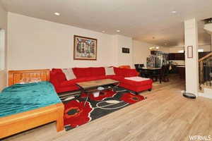 Living room with a chandelier and light hardwood / wood-style flooring