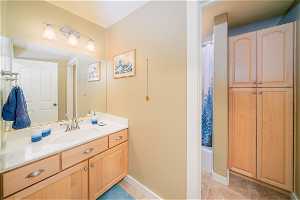 Bathroom with shower / bath combo, tile floors, and vanity