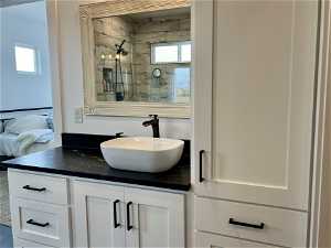 Primary Bathroom featuring a wealth of natural light and oversized vanity