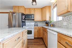 Kitchen featuring, tasteful backsplash, dark hardwood / wood-style flooring, and sink