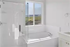 Bathroom with plus walk in shower, a wealth of natural light, and vanity