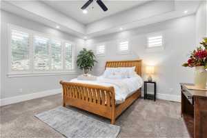 Bedroom featuring ceiling fan and dark carpet
