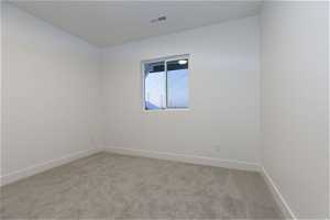 Unfurnished room with light carpet