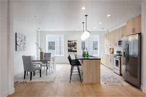 2nd floor kitchen and great room. Photo is from a similar unit in the development. Some fixtures may differ