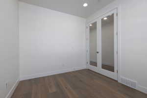 Unfurnished room with french doors and dark hardwood / wood-style floors