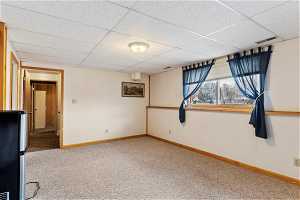 Carpeted empty room with a paneled ceiling