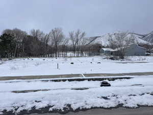 Snowy yard with a mountain view