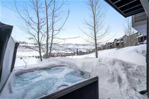 Snowy yard with a hot tub