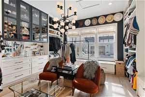 Huge walk-in closet with dressing areas and plenty of cabinetry and hanging